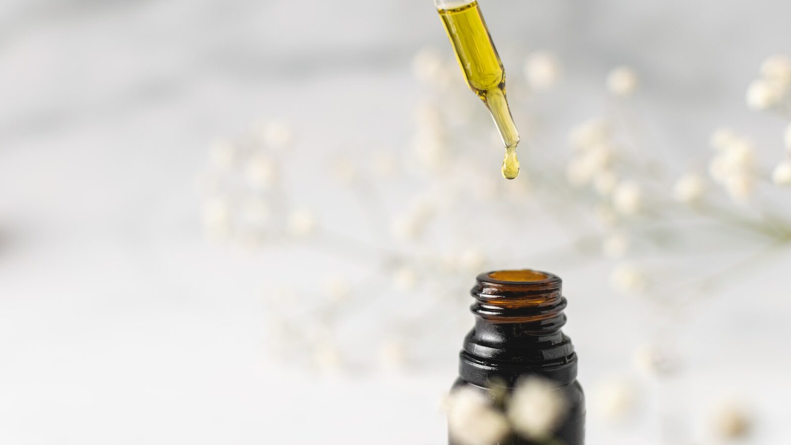clear glass bottle with yellow lid
